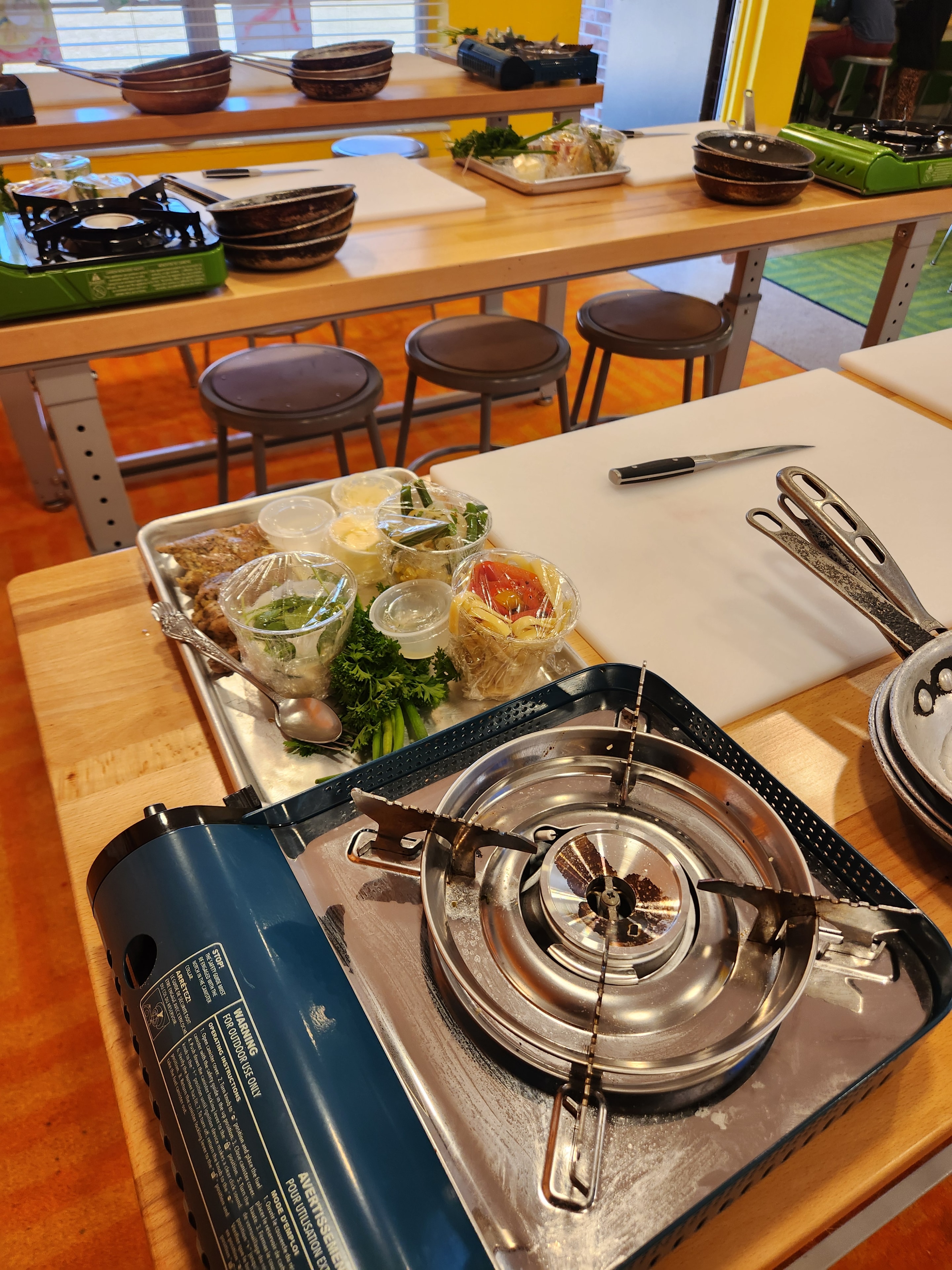 Portable burner station with prepped ingredients and cutting board