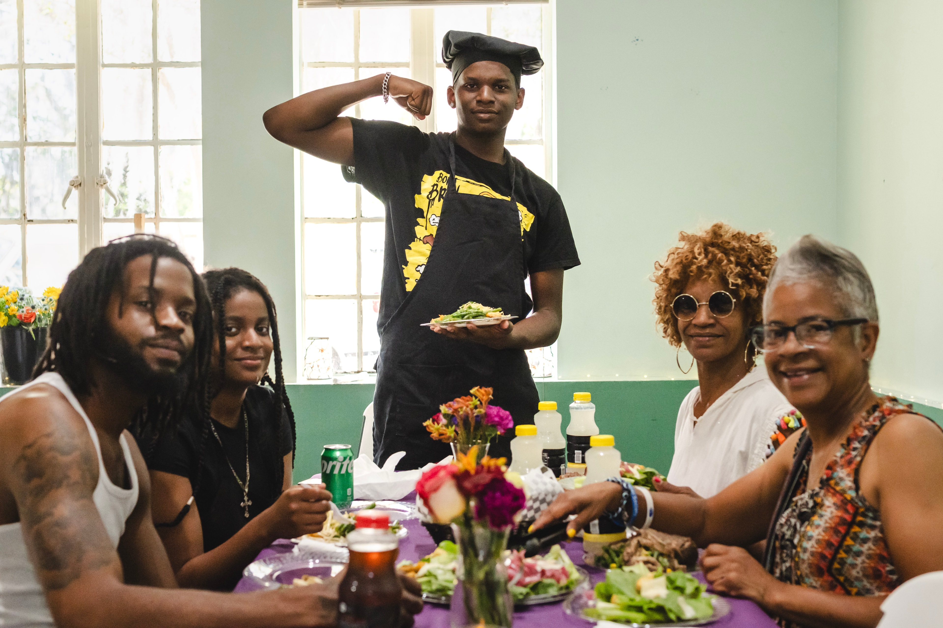 Young chef presenting a dish to a dining table