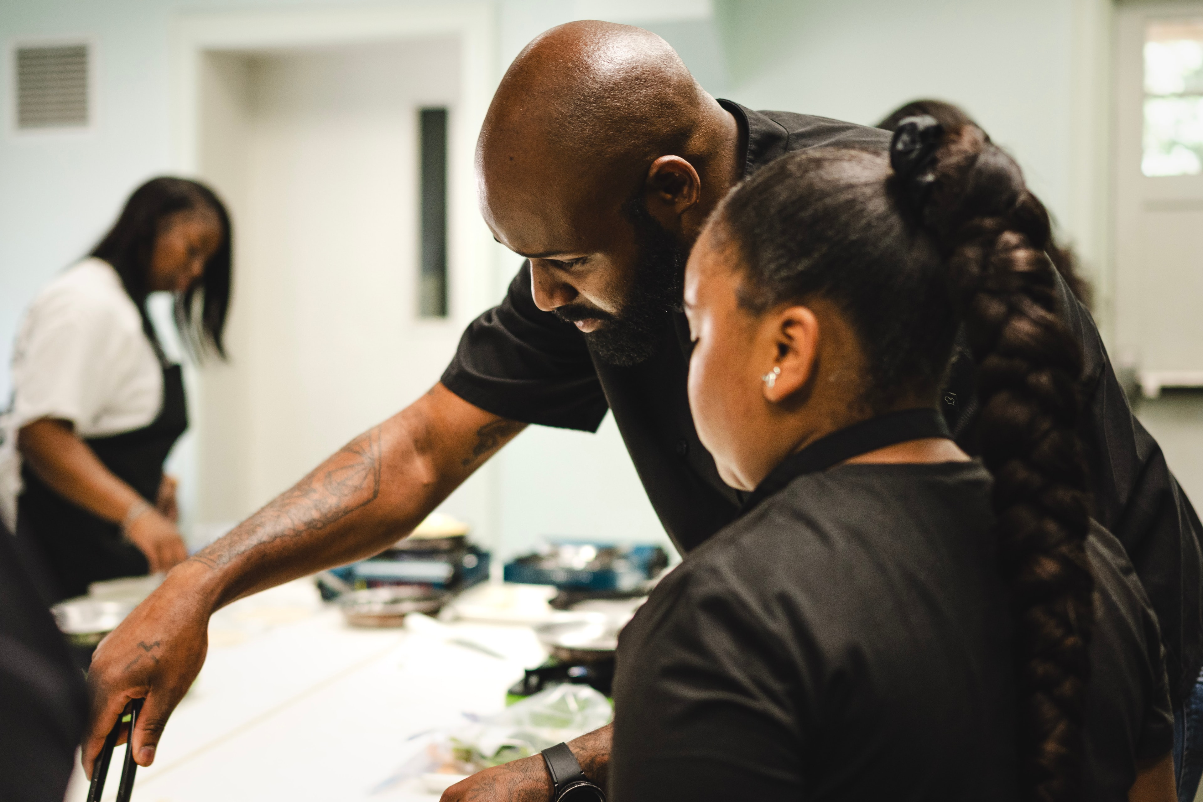 Chef Carl mentoring a student at the kitchen counter