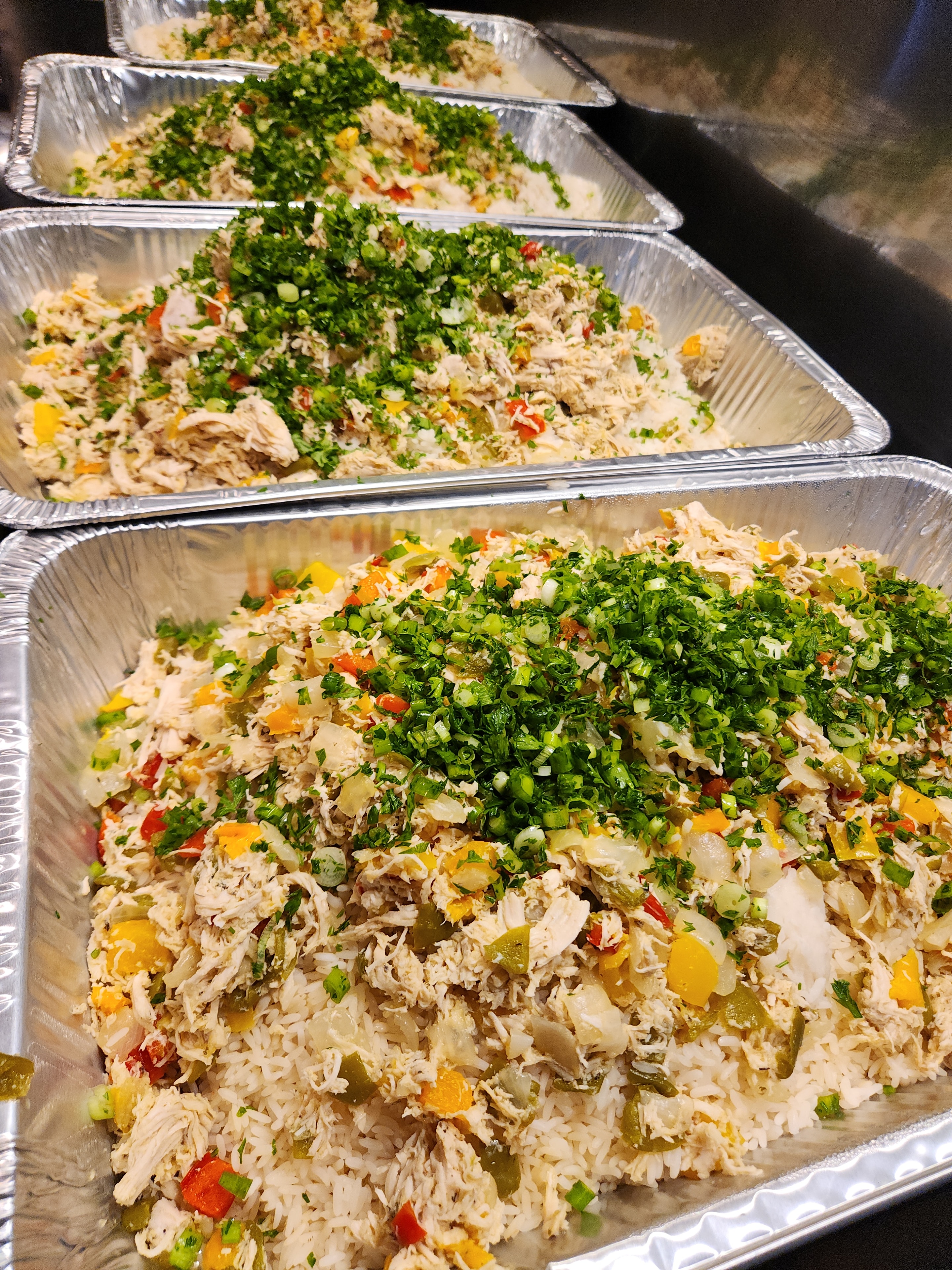 Chicken and rice dishes prepared in bulk for distribution