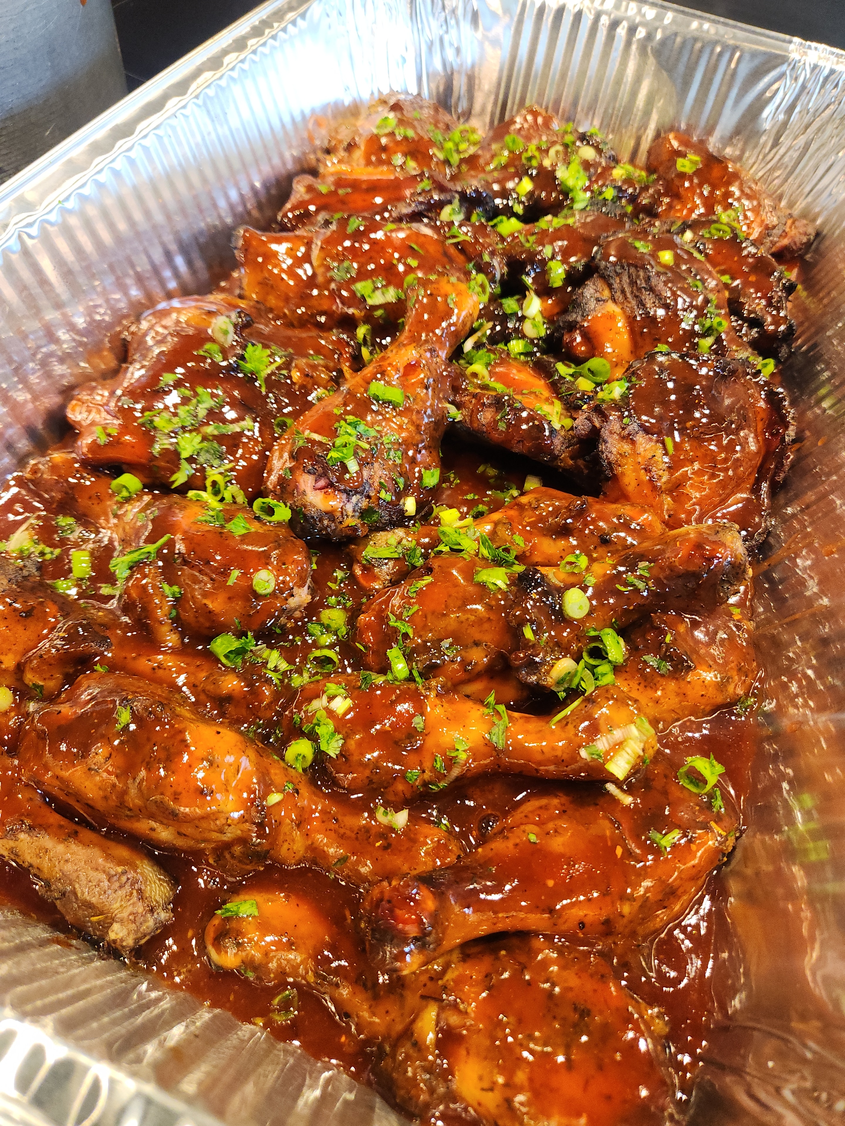 Glazed BBQ chicken prepared for community meal day