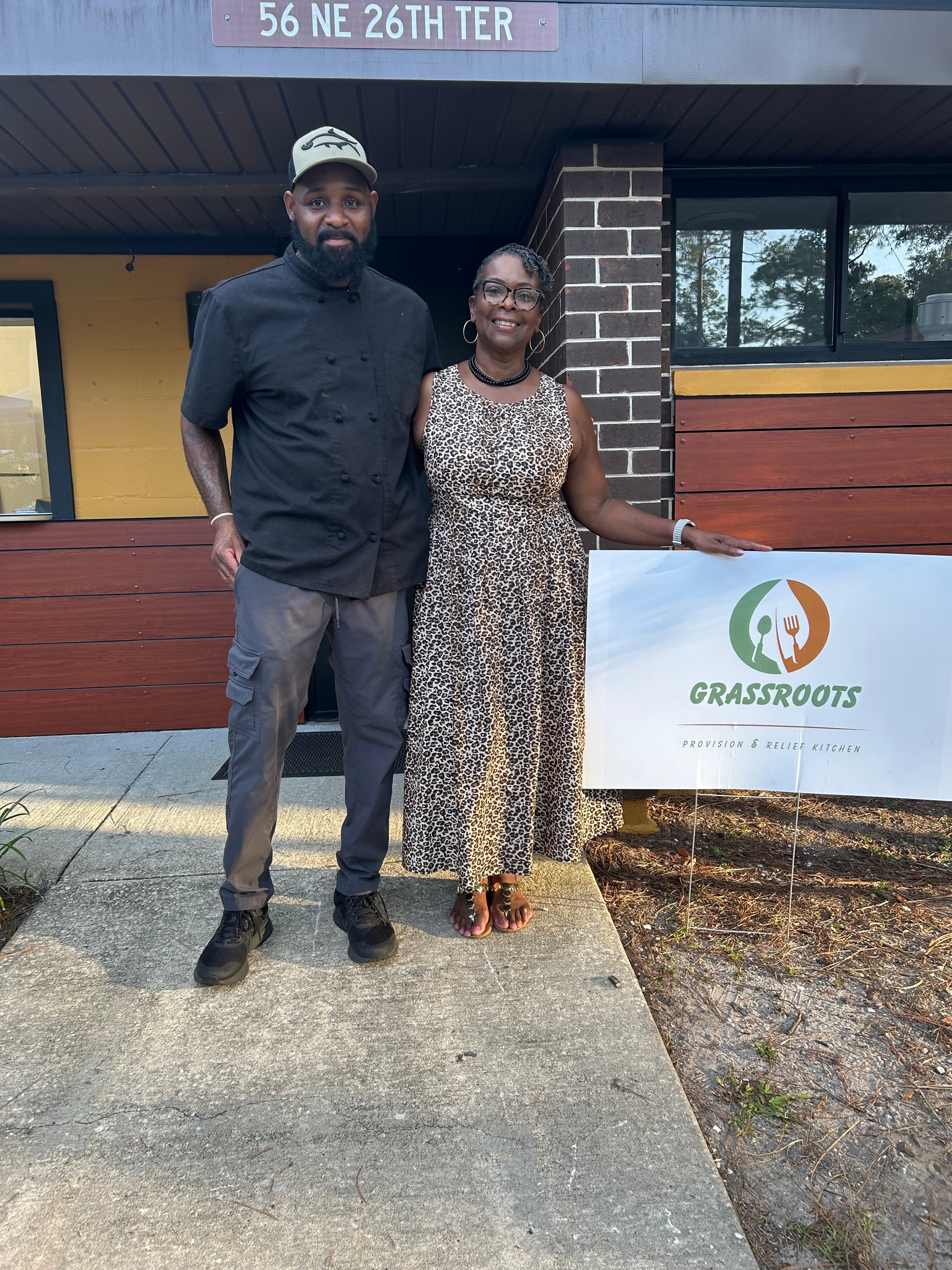 Chef Carl and Gainesville Housing Authority CEO Pamela Davis posing outside of Grassroots Community Kitchen
