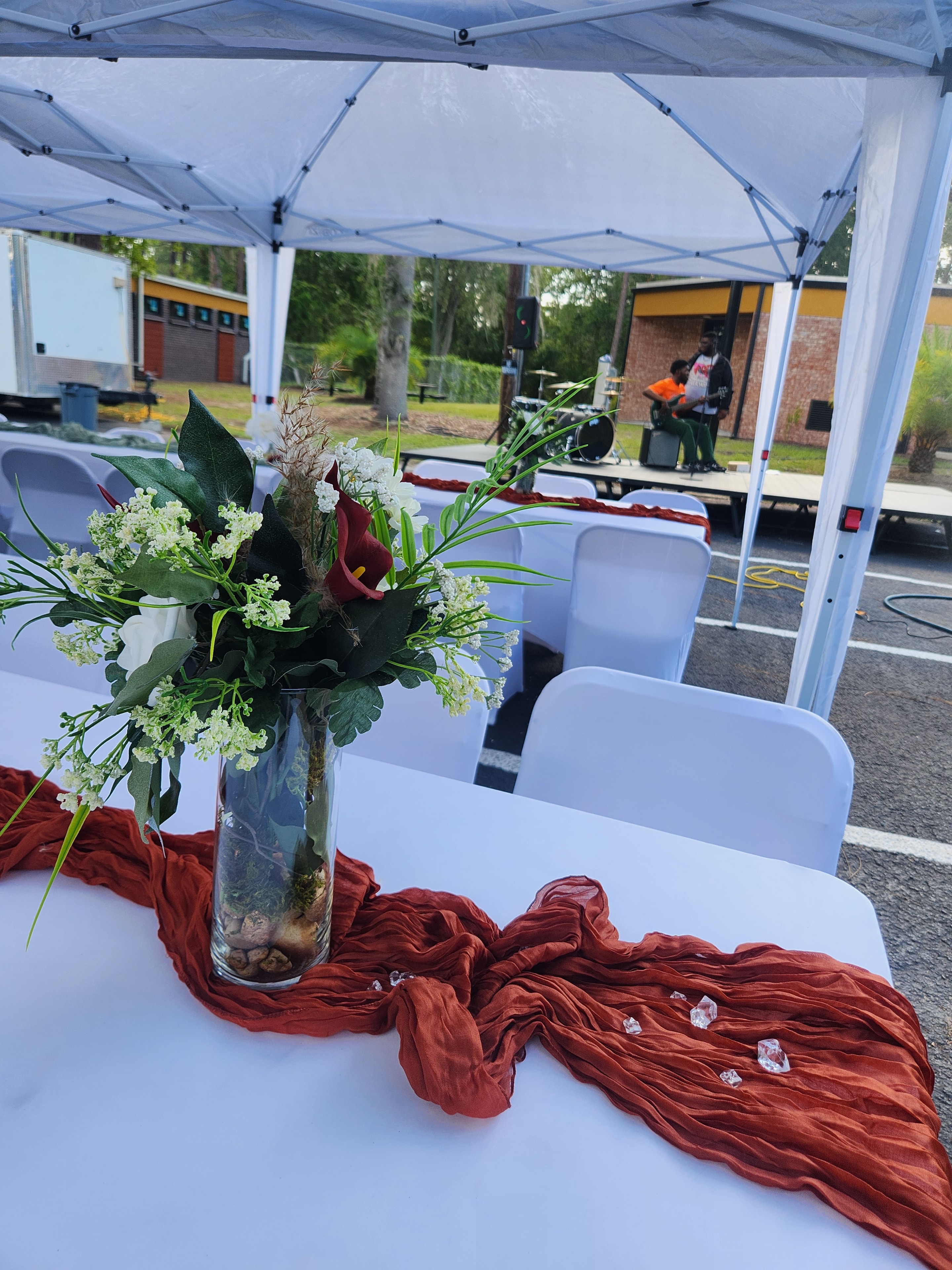 Beautifully decorated outdoor community dinner table with floral centerpiece