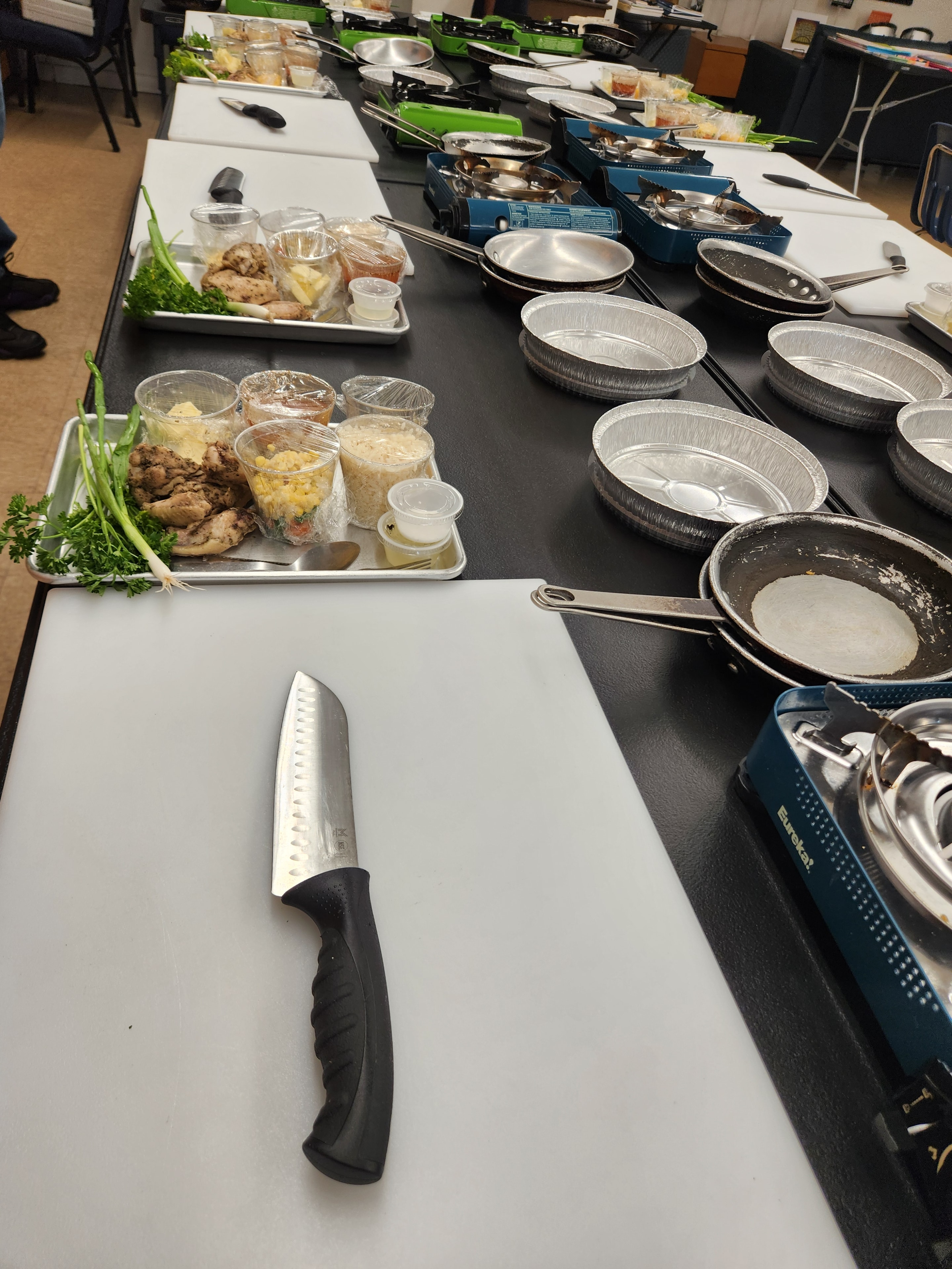 Cooking class prep station with pans and ingredients